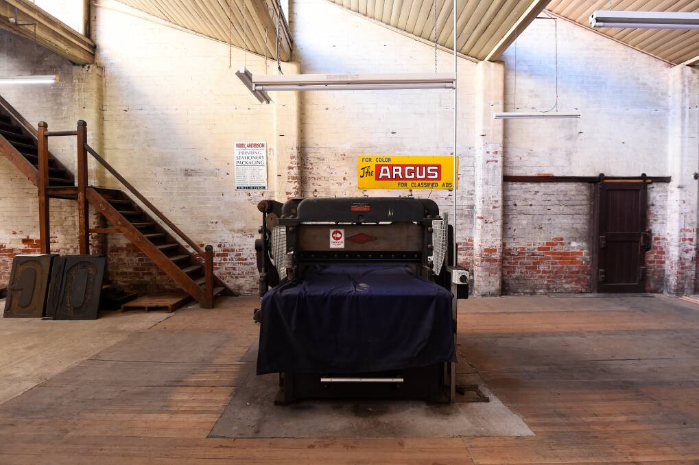 Not making the cut: An English-made guillotine sits idle in the building, in front of an Argus enamel sign. Berry Anderson also had their own newsagencies. Picture: Adam Trafford.