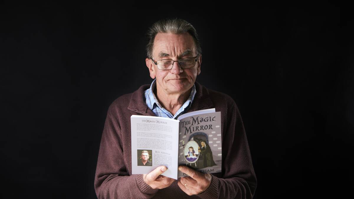 First time author: Roy Askham with his children's book, The Magic Mirror. Picture: Luka Kauzlaric.