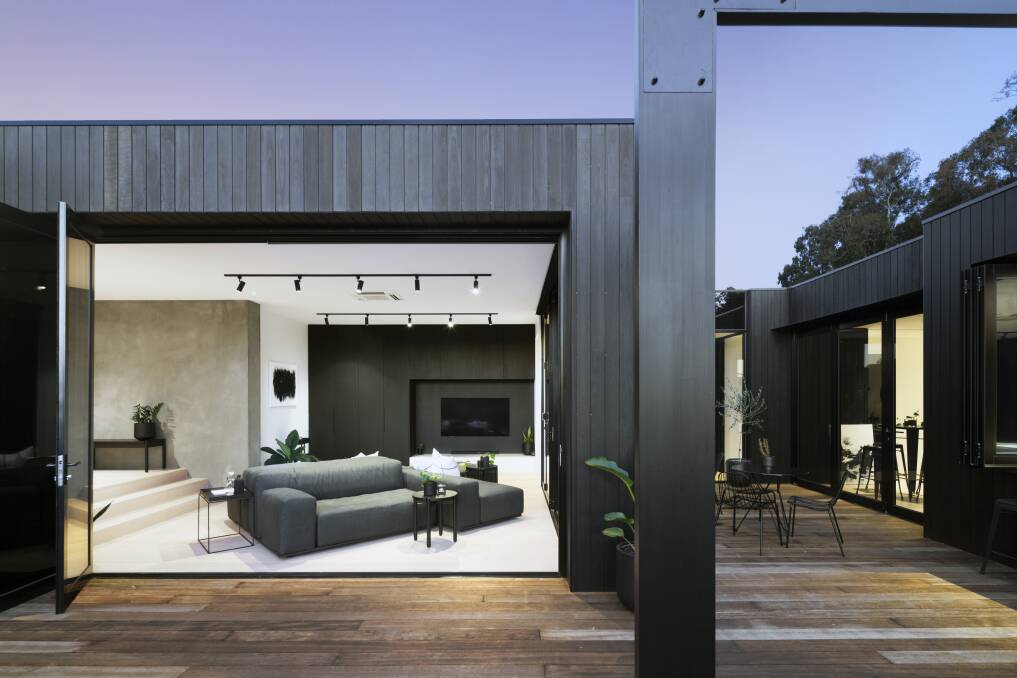 Above: The dark stained spotted gum contrasts with the natural timber deck, which as it ages will turn grey. picture: H-Studios.