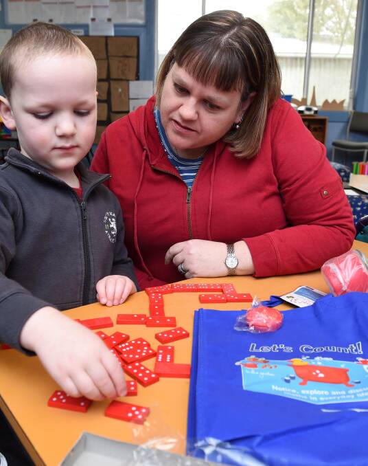 Let's Count: Dylan Rowe with his mother Anita using dominoes to teach himself the basics of adding and subtracting at Iris Ramsay kinder. Picture: Lachlan Bence.