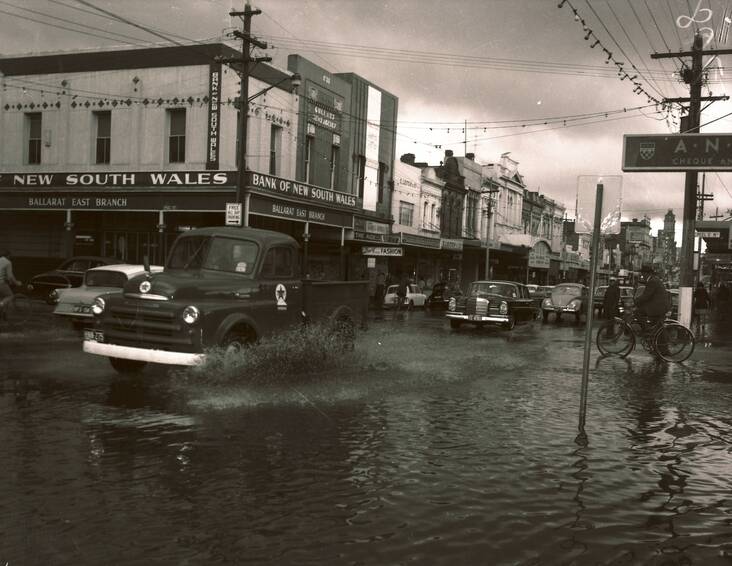 Above, a lesser impact: Low-level flooding on the corner of Peel and Bridge streets in the late 1960s.