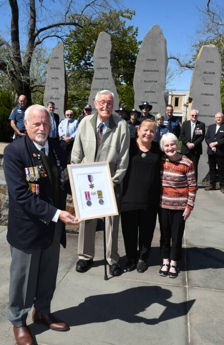 A life honoured: Veteran and historian Ron Lee hands the decorations of George Oakes to 91 y.o. Noel Sweatman, Oakes's nephew. With him are Trish Blacket, who found the medals, and 84 y.o. Glynis Brown, who worked with Oakes at the Base Hospital. In the background are members of the ambulance and fire services, former colleague of Oakes Bob Harrison, BHS CEO Dale Fraser and Ex-POW committee members Bill Bahr and Ray Mende. Picture: Lachlan Bence.