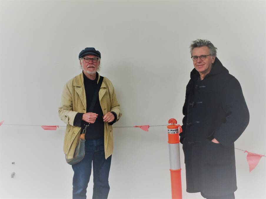 Unhappy: Ratartat artists Geoff Bonney and Peter Widmer standing at the site of the missing mural on Tuesday. JLL property management says there are no plans for new artwork on the wall. Picture: Caleb Cluff.