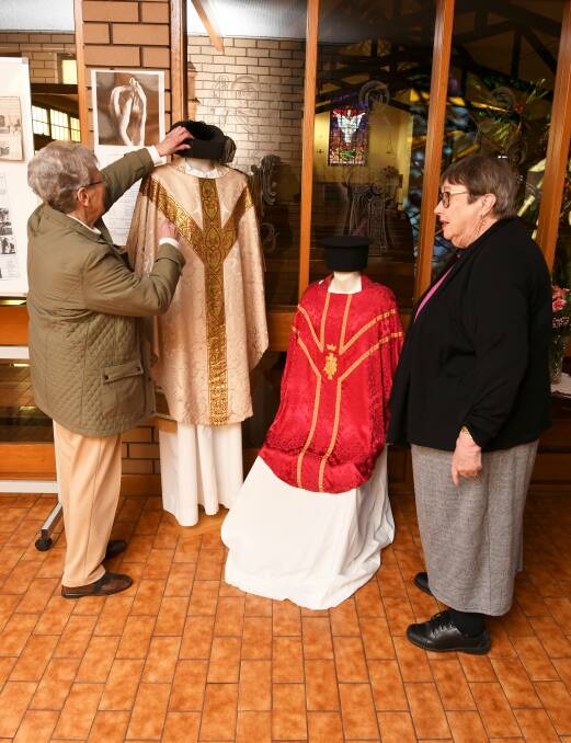 Historic vestments: Mary Akers (left) and  Ann McKee inspect ecclesiastical vestments for St Matthew's 125th Anniversary. Picture: Lachlan Bence.