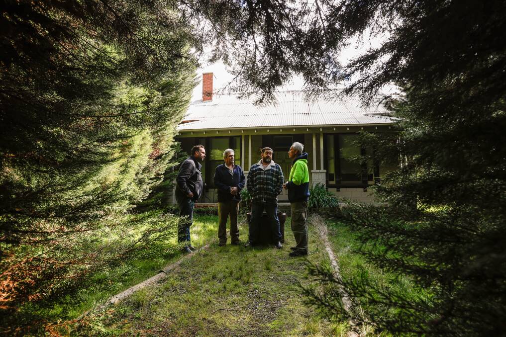 Brett Edgington, Brian Foo and Mick Trembath, advocates for Victory, talk to Charles Zhang outside the now-preserved house. Picture by Luke Hemer.