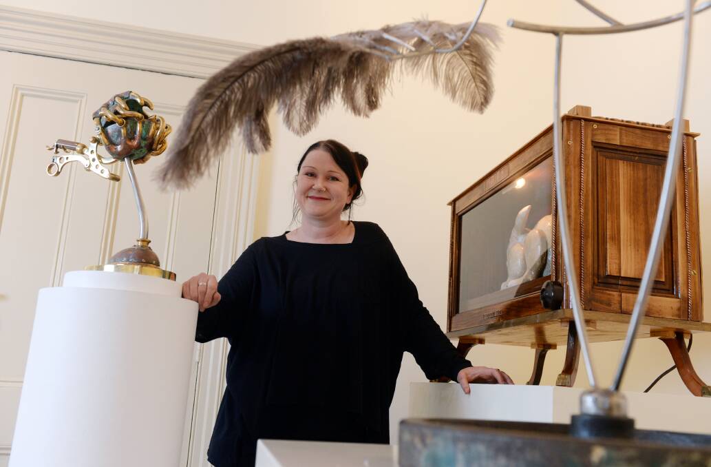 Moving sculptures: Curator Kiri Smart with some of the works on display at her exhibition Momentum: Kinetic-Robotic-Mechanic. Picture: Kate Healy.