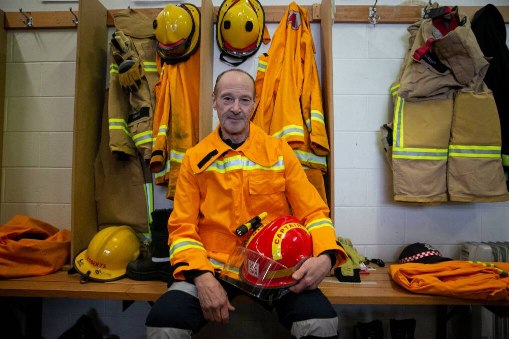 One story: Captain Terry Crisp kitting up, June 2020 Mount Hotham, north-east Victoria. "The Mount Hotham CFA saved Dinner Plain. Apparently the fire was coming straight at them and they thought they were gonna get wiped out, but I think a late weather change saved them. One side of Terry is that he's a CFA volunteer, but he also works at the ski field. The whole season was shut down because of COVID," said James Wiltshire. Picture: James Wiltshire.
