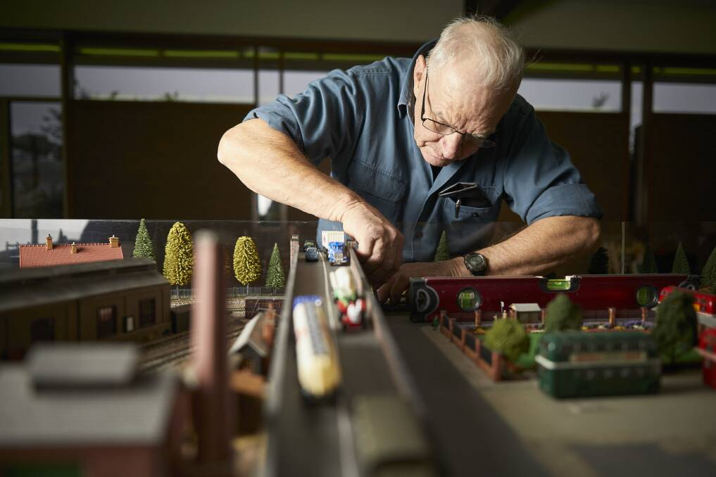 Building a world (below): Michael Lynch of Aireys Inlet prepares for the exhibition. Picture: Luka Kauzlaric