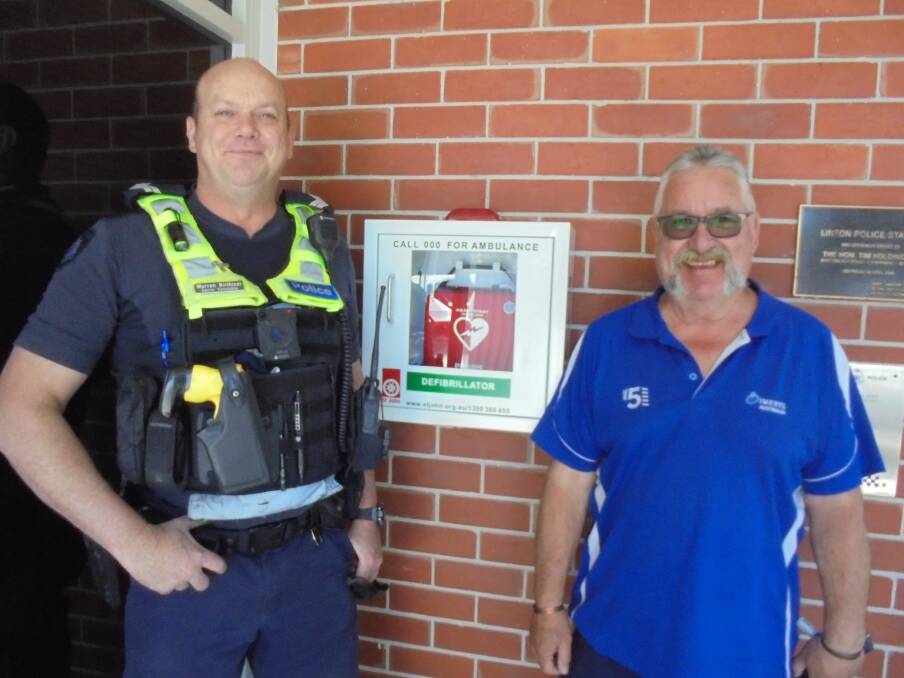 Xmas lifesaver: Sen. Constable Warren Birthisel of Linton Police with Neil Park of Imerys Minerals Australia and the new defibrillator, days before it saved a life.