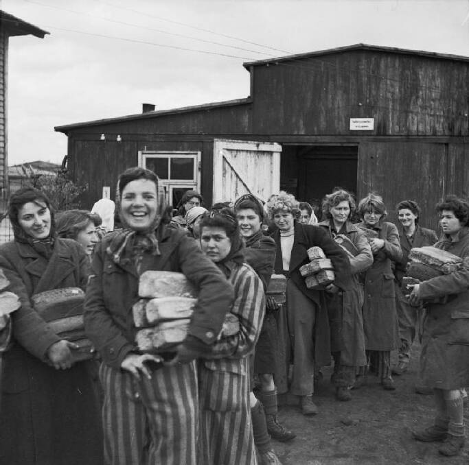 Bergen-Belsen: Inmates take loaves of bread following the liberation of the camp.