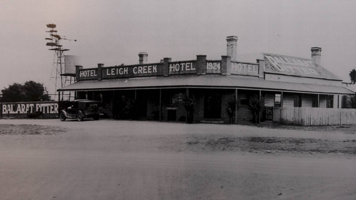 A landmark: The Leigh Creek Hotel around 1924. The facade is still standing and visible although damaged and covered in advertising and paint.