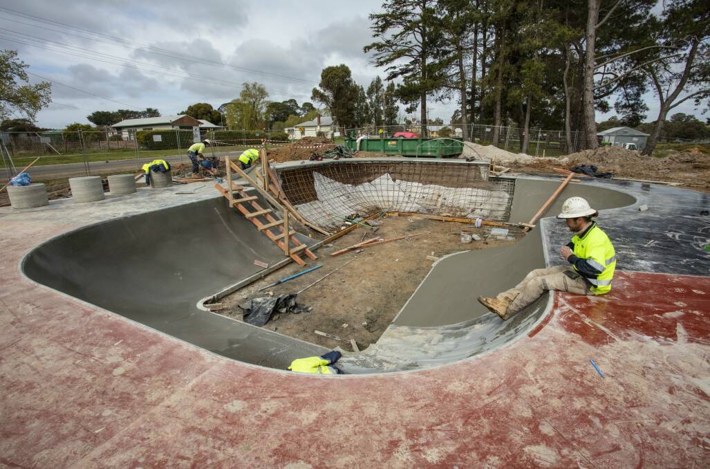Specialised construction: Workers from skatepark specialists Convic forming the skate bowl at Snake Valley. Picture: Clayton Keefe.