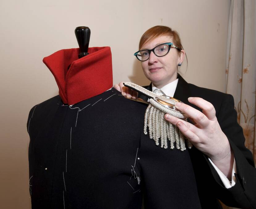 Reconstructed history: Seamstress and historian Megan Anderson holds an epaulette to her partially-constructed uniform of Charles La Trobe. Picture: Lachlan Bence.