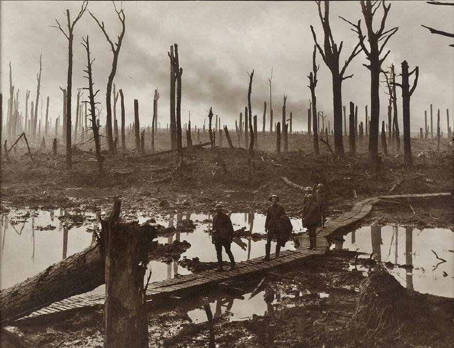 Soldiers of an Australian 4th Division field artillery brigade on a duckboard track passing through Chateau Wood, near Hooge in the Ypres salient, 29 October 1917. The leading soldier is Gunner James Fulton and the second soldier is Lieutenant Anthony Devine. The men belong to a battery of the 10th Field Artillery Brigade. Picture: AWM.
