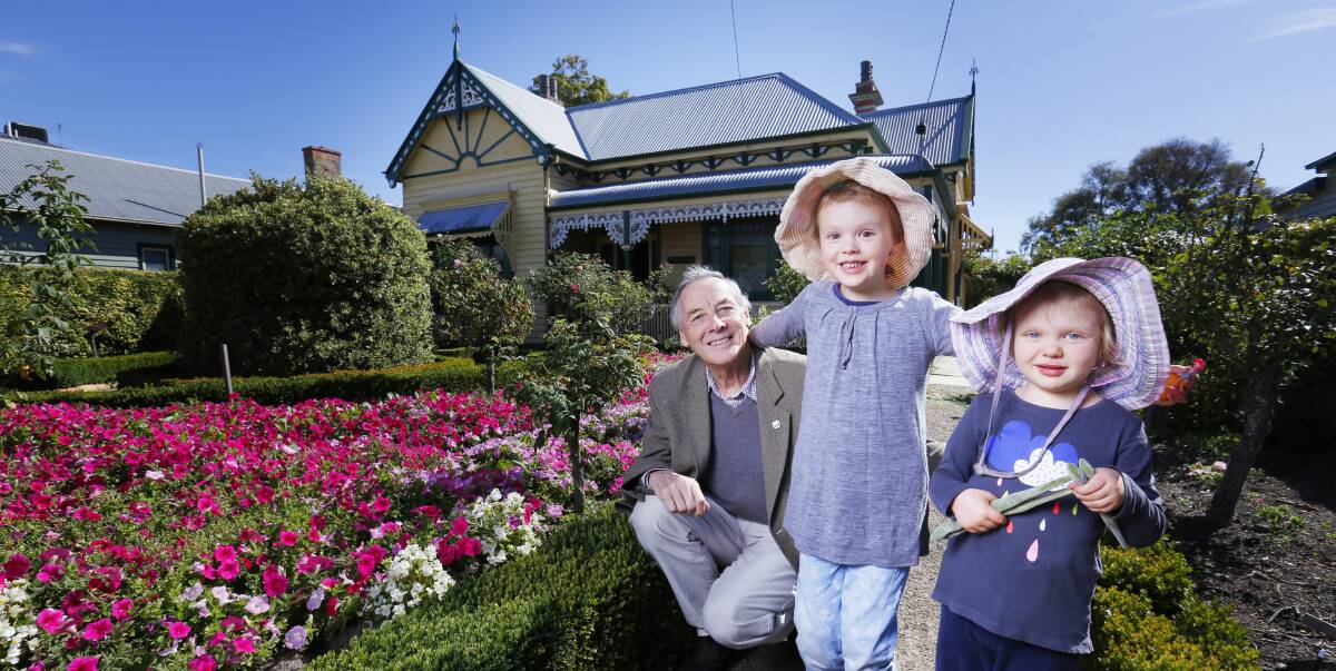 Generations: Michael Taffe with his granddaughters Peggy and Eleanor in the front garden of Hymettus. Photo: Luka Kauzlaric.