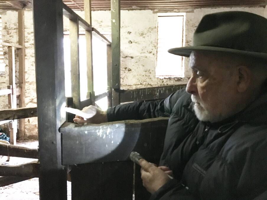 Years of research: Dr Ian Evans is almost 80. Here he examines a burn mark in a stable in Western Victoria. Picture: Tully Brookes.