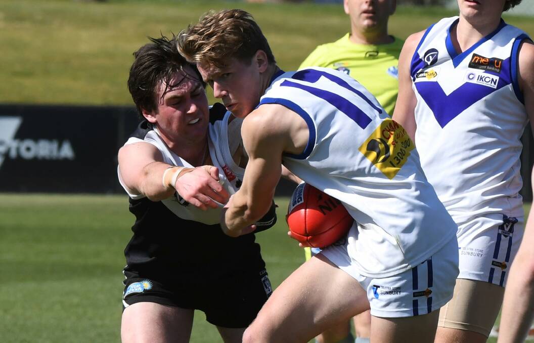 NO ESCAPE: Sunbury's Riley Eales is wrapped up by his North Ballarat City opponent, North had the upper hand all day.