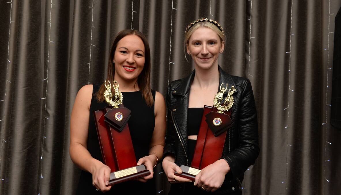 SHARED HONOUR: Redan's Ruby Parry and Sunbury's Ashleigh Hardy proudly show-off their Sally McLean Trophies after finishing Monday's A grade netball best and fairest vote count tied on 19 votes. Picture: Kate Healy.