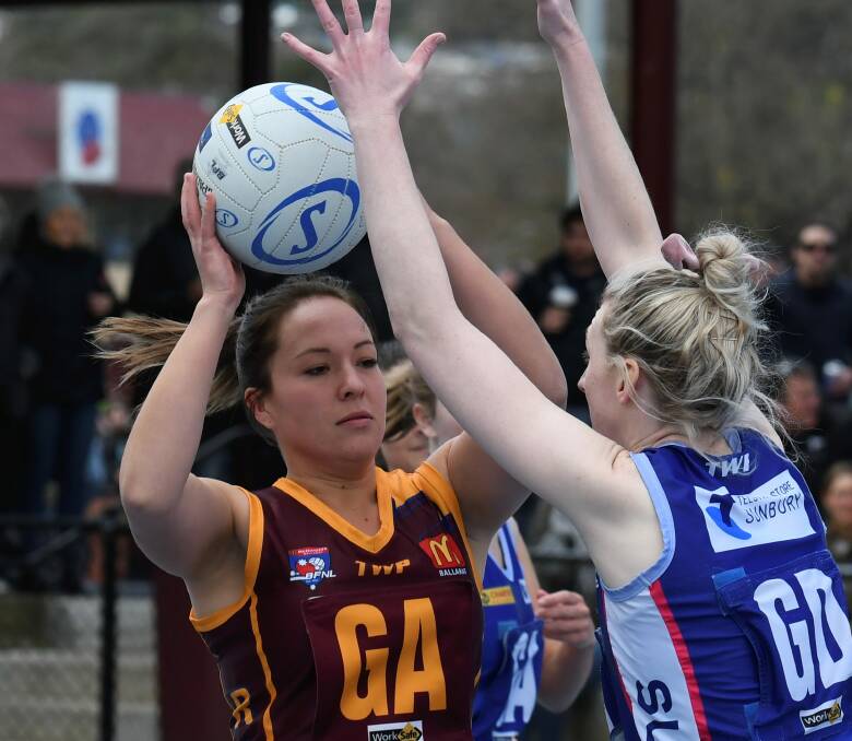PRESSURE: Redan's Ruby-Rose Parry comes under heavy Sunbury pressure as she looks to find a teammate in the preliminary final.