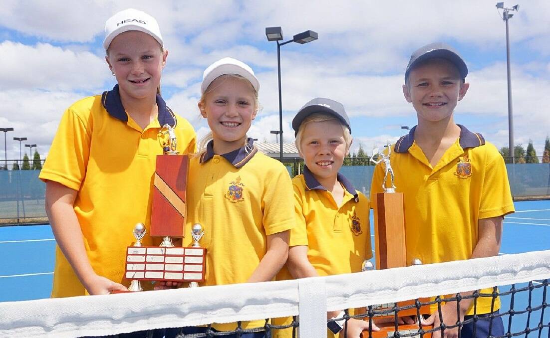 CHAMPIONS: Ballarat Grammar's Addison Maxted, Lucy Alcock Harry Bentley and Harry Bryant show-off their Head Primary School Tennis Championships trophies.