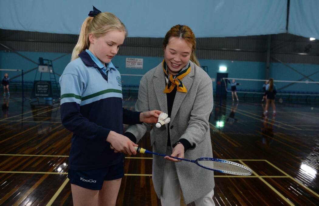 LEARNING: Olympian Victoria Na, who was joined by Ballarat's Erin Carroll on Wednesday, shows Jamila Jones the ropes at Ken Kay Badminton Centre. Picture: Kate Healy