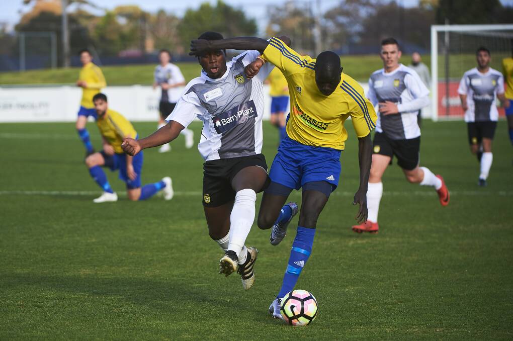 HOT PURSUIT: Vikings Kuanjal Tuany, who played his 100th game for the club on the weekend, tussles with his United opponent at St Georges Reserve. Pictures: Luka Kauzlaric