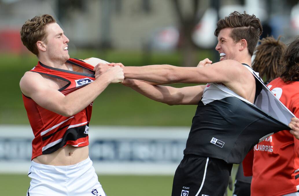 TUSSLE: North Ballarat's Rowan Marshall and Frankston's Daylan Kempster duke it out in the quarter-time scuffle on Saturday.
