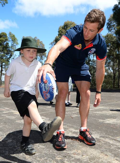 Western Bulldogs star Dale Morris takes last year's football clinic at Magpie Primary School.