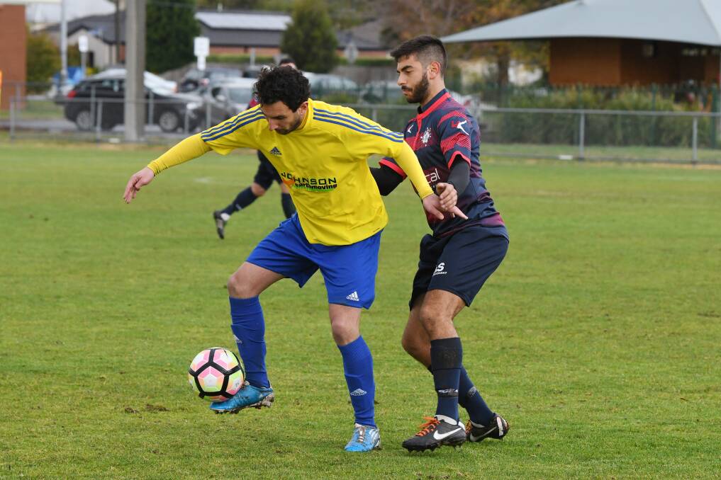 TUSSLE: Sebastopol Vikings' Will Georgiou and Epping City's Lucas Ruffino jostle for position over the ball on Saturday.