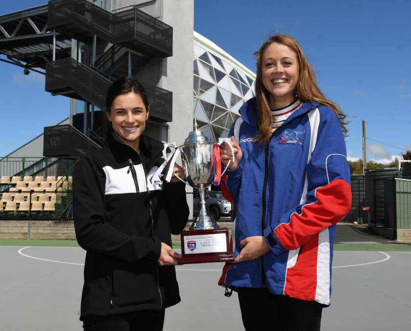 BIG STAGE: North Ballarat City's Stacey McCartin and East Point's Bethany Smith get their hands on the cup ahead of Saturday. Picture: Lachlan Bence