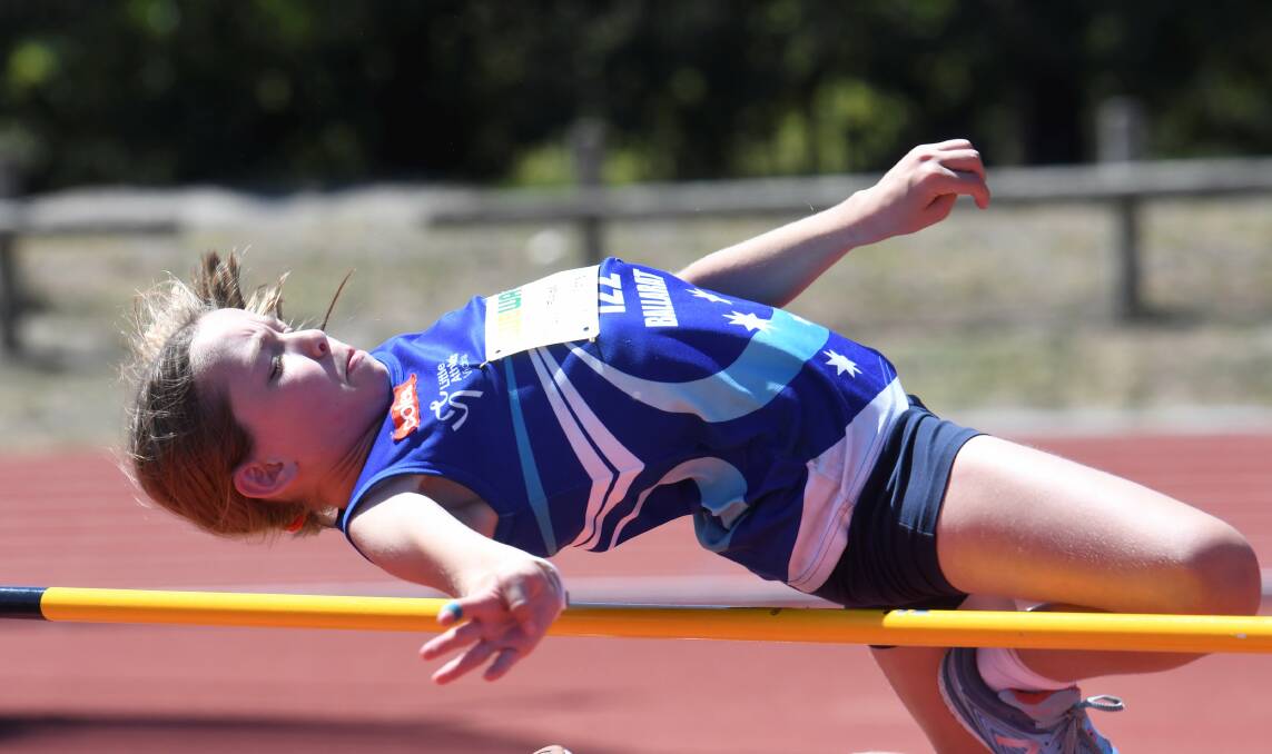 JUMP: Ballarat Little Athletics star Lucy Fraser looks to clear the bar during the high jump at Llanberris on the weekend.