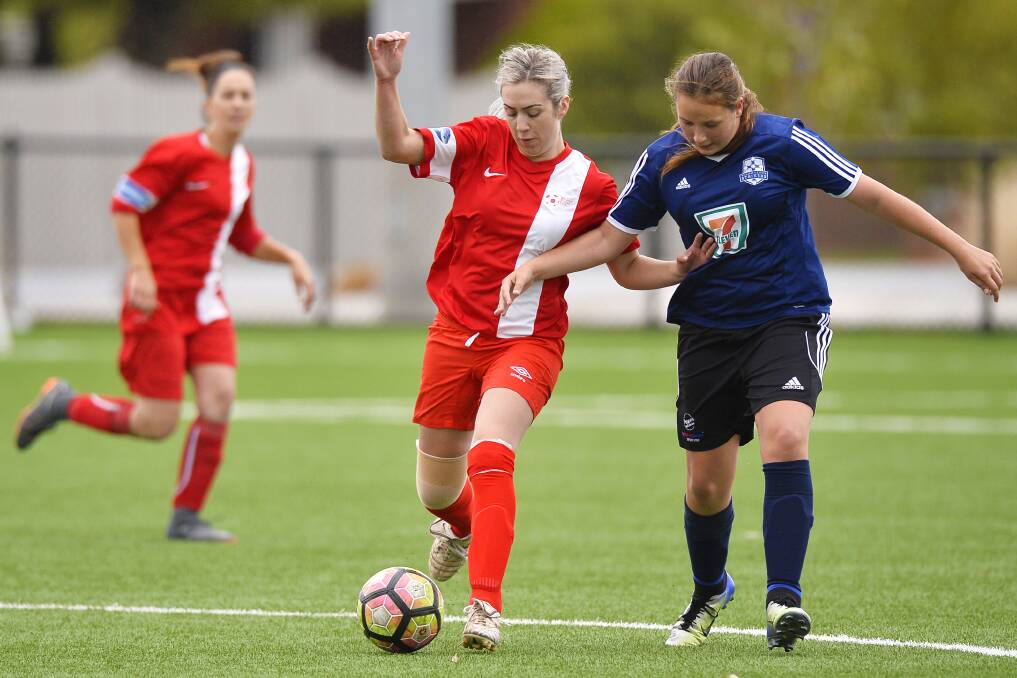 POSSESSION: Ballarat's Simone Boorn-Wells keeps control of the ball as young Striker Chloe Muzik applies the pressure.