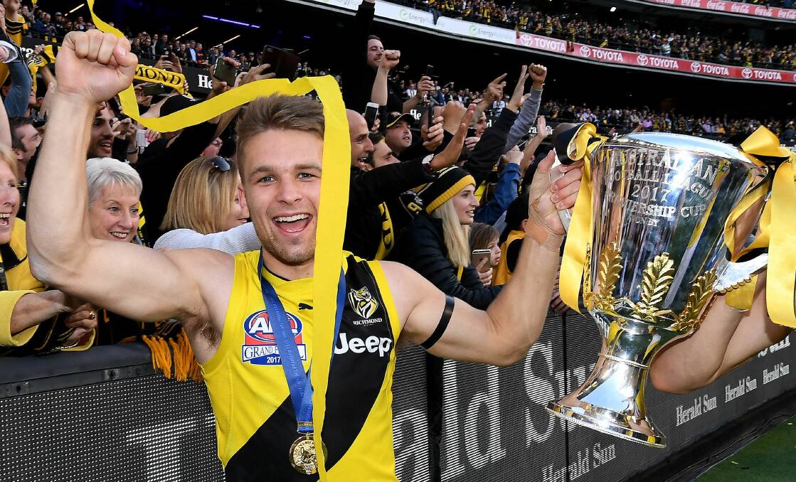 GLORY: Ballarat boy Dan Butler holds the premiership cup after Richmond's 48-point win over Adelaide in the AFL grand final on Saturday. Picture: AAP Image/Julian Smith.