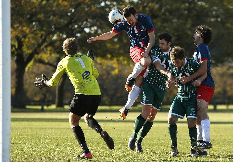 HEADER: Victoria Park's Shane Jones soars above his Forest Rangers opponent to connect with the incoming ball.