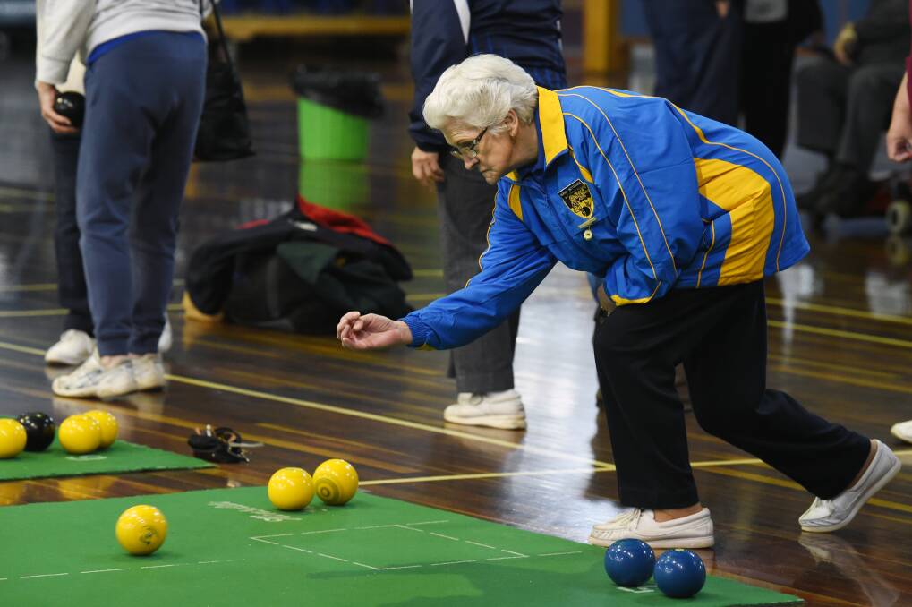 IN MOTION: Ballarat bowler Norma Betteridge sends her bowl down the mat during Monday's action of the inter-group indoor bias bowls championships. Picture: Kate Healy