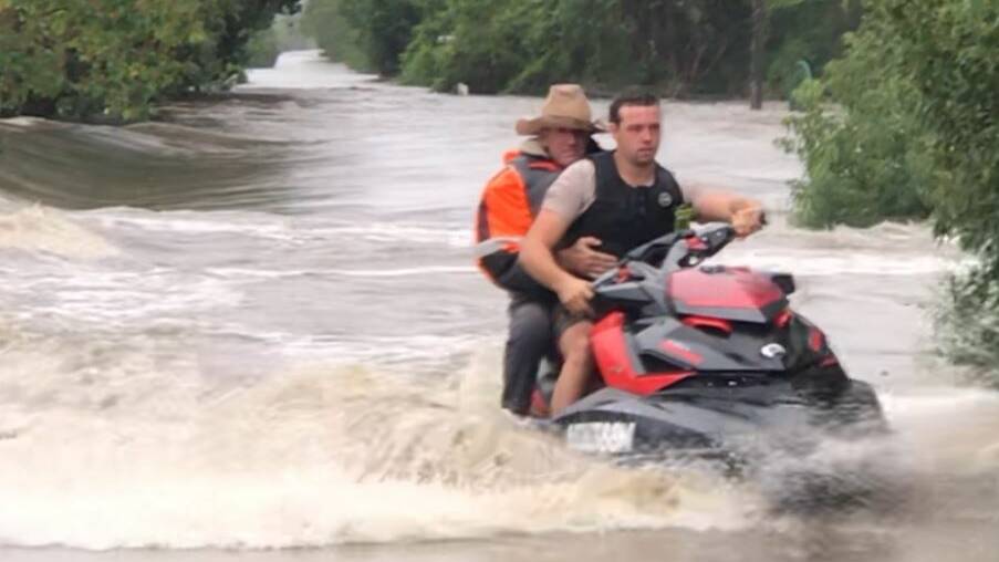 Jake Elven takes one of the couple in need of help to safety on the back of his jet ski.