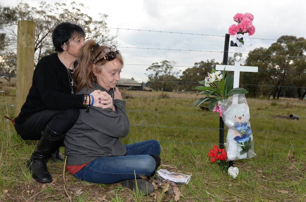 Helina Gordon, a witness at the crash which killed Alex Baines, and Alex's mother Norelle at the site of the accident in Bunkers Hill almost three months on since the collision. Picture by Kate Healy
