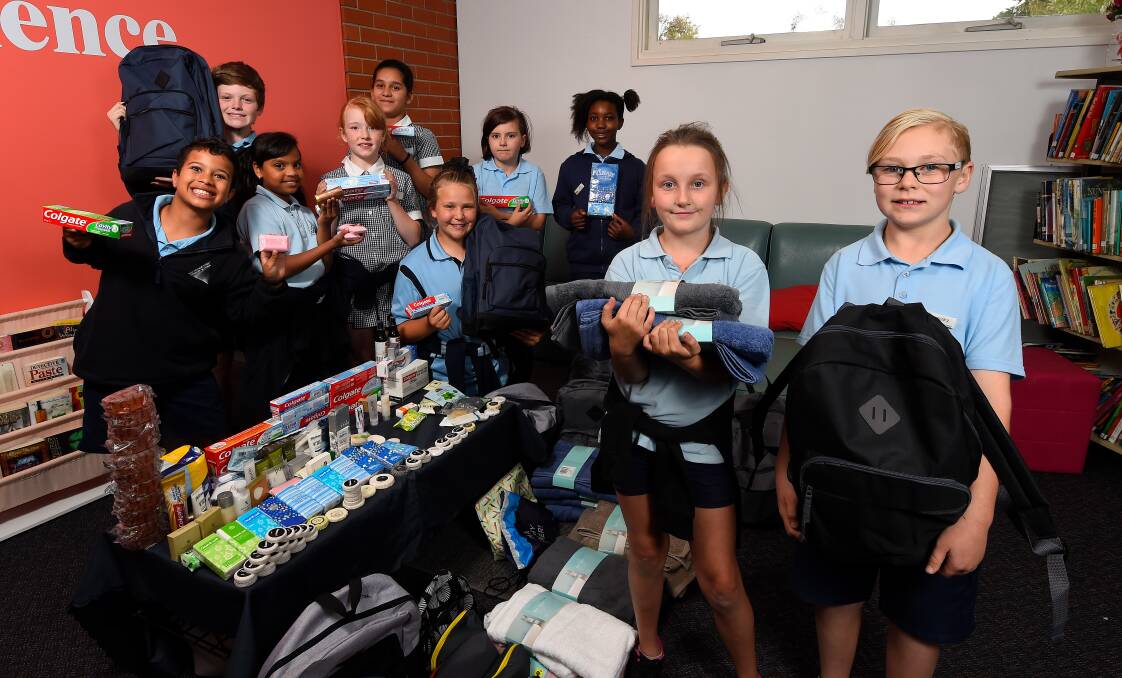 Macarthur Street Primary School students Nate, Fyn, Susitha, Astrid, Ips, Kira, Audrey, Kito, Soriah and Rory pose with items collected to donate to the shower bus. Picture: Adam Trafford
