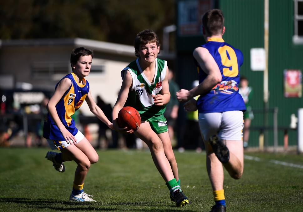 PLAYING DAYS: Rokewood-Corindhap's Darcye Moloney and Learmonth's Jesse Geddes and Jed Cubitt battle it out in an under-15 clash this season. Youngsters are being encouraged to enter a competition run by Lachie's Legacy.