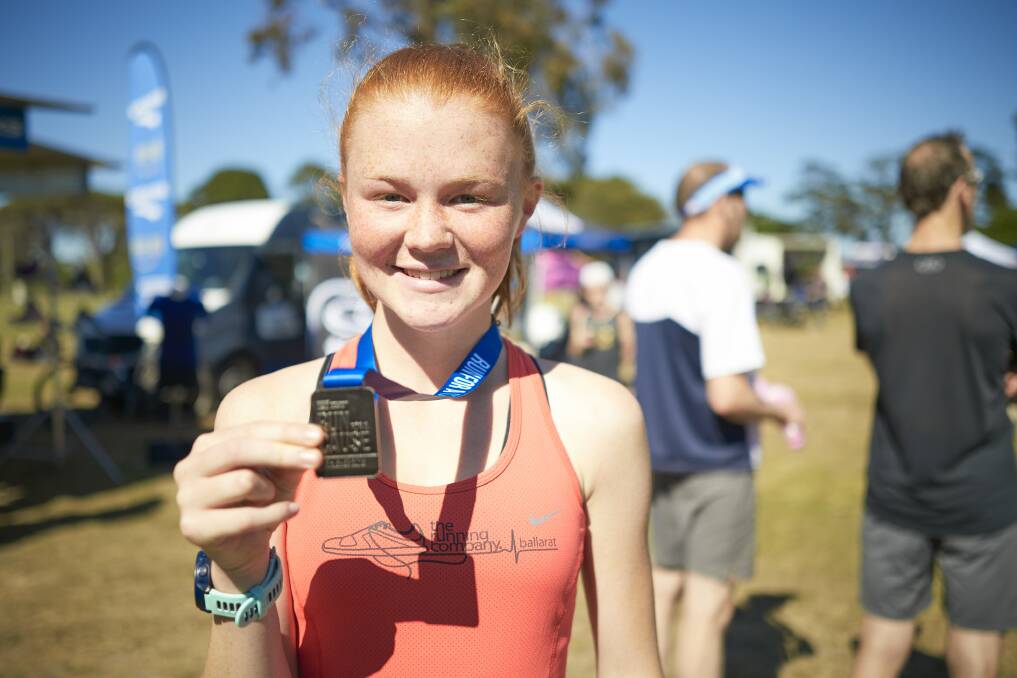 ALL SMILES: Georgina Mees took out the female 5km category with a run of 19.13min. Harry Sharp won the 5km male division after recording 16.18min. Picture: Luka Kauzlaric.