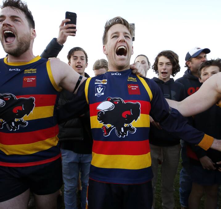 HAPPY DAYS: Senior captain Michael Foster sings the Beaufort song on the ground after winning Saturday's grand final against Buninyong. Picture: Dylan Burns.