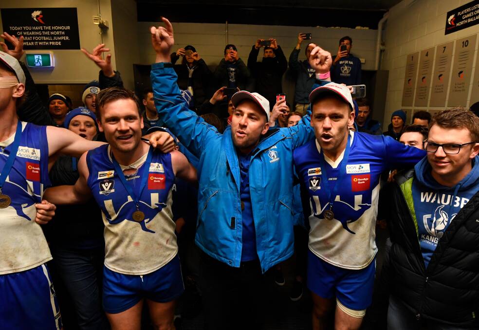 HOLY GRAIL: Matt James celebrates with Tom Nash (left) and Paul Dodds in the rooms at Mars Stadium after Waubra's 52-point thrashing of Hepburn. Picture: Adam Trafford.