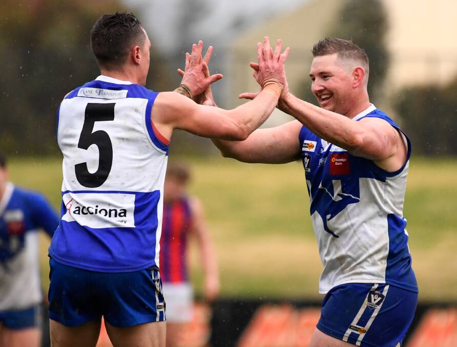 HIGH FIVES: Will Corbett and John Coleman embrace during the Roos' emphatic grand final display. Waubra extended its lead in every quarter on Saturday.