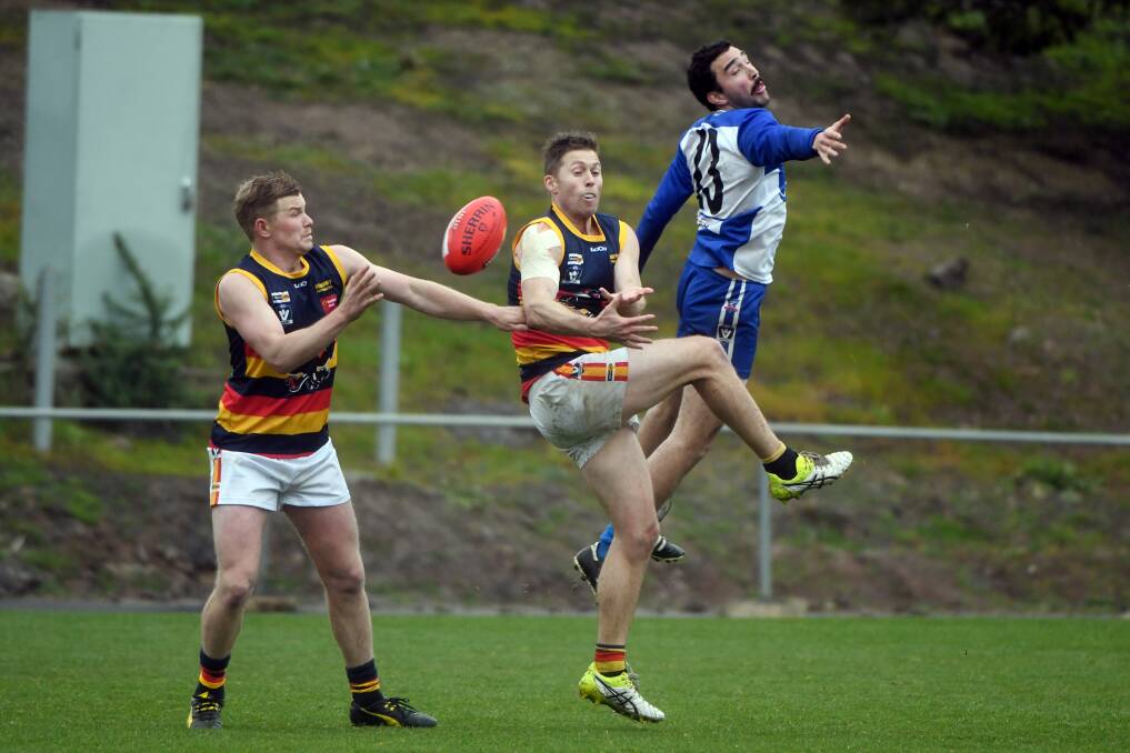 ONE VERSUS TWO: Waubra's Alex McPherson (right) tries to stop Beaufort opponents Lachlan Murray and Jarrod McCorkell on Saturday.