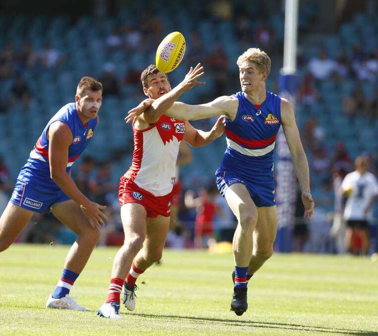 BIG STAGE: Western Bulldogs player Tim English (right) is pictured in action against Sydney in 2017. That game was just English's second at AFL level after he was drafted to the club at the end of 2016.