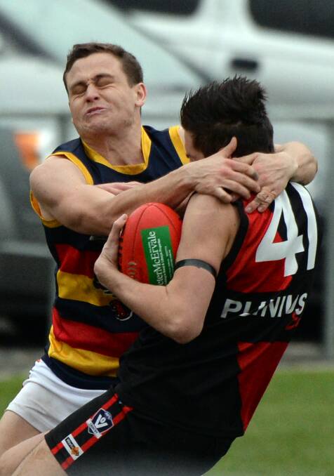 HIGH: Beaufort's Jack Duke catches Buninyong rival Mitchell Arnold over the shoulder in a tackle on Saturday. The Bombers won a thriller by five points. Picture: Kate Healy.