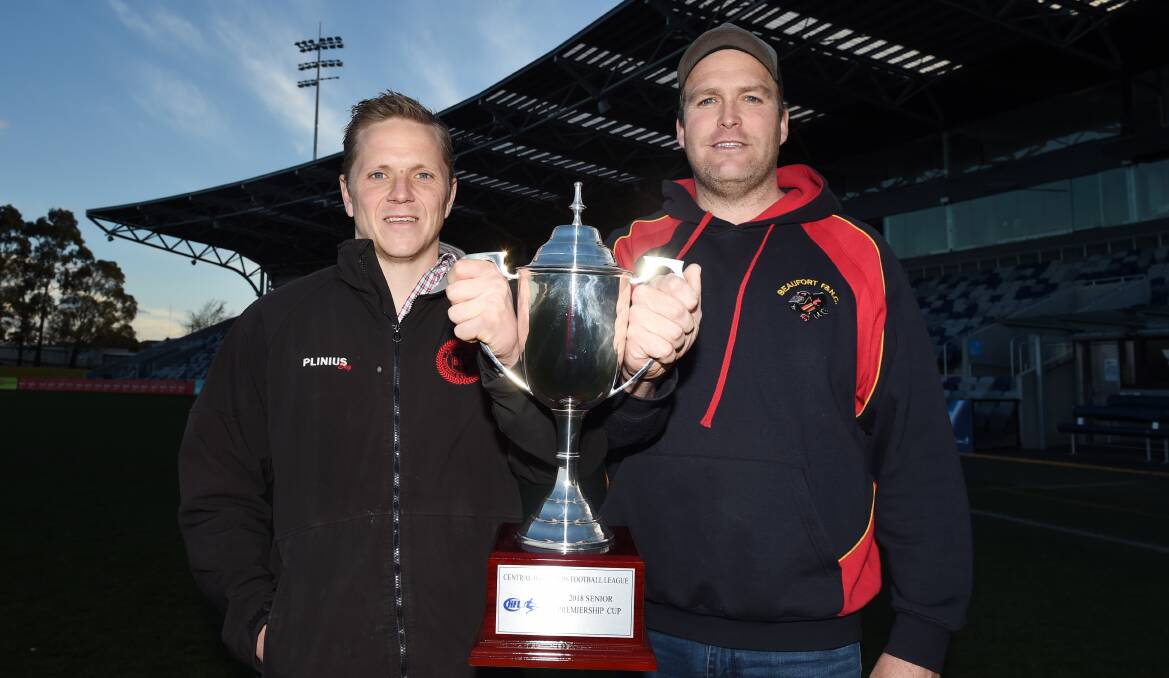 HOLY GRAIL: Buninyong coach Jarrod Morgan and Beaufort coach Rohan Brown got a feel for the 2018 CHFL premiership cup at Mars Stadium on Wednesday. Picture: Kate Healy.