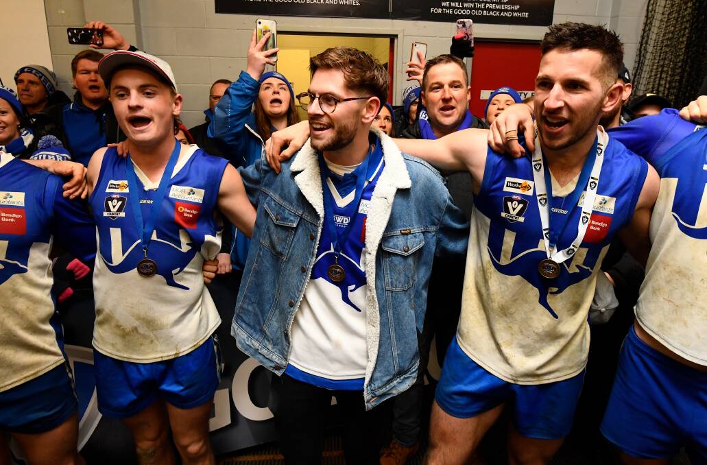 Jarred Crabtree (centre) sings the Waubra song after the grand final success. Pictures: Adam Trafford.