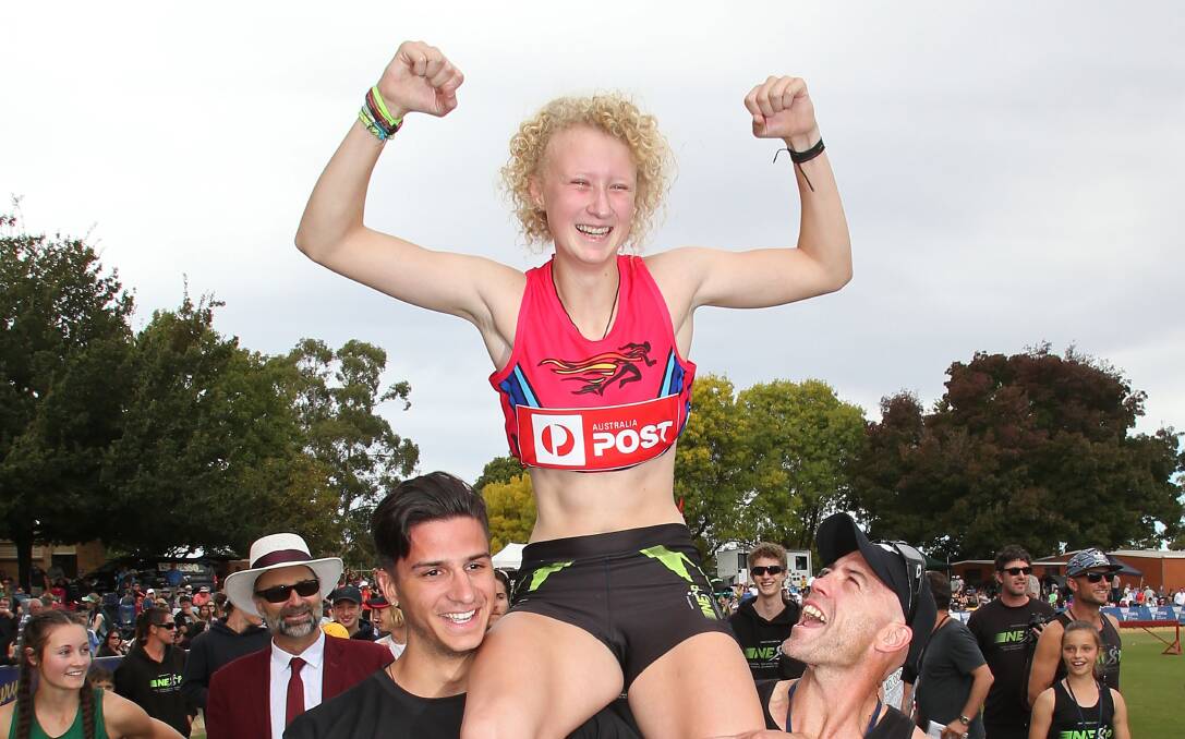 CHAMPION: Liv Ryan is lifted into the air after claiming victory in the Stawell Women's Gift. The 16-year-old won in a time of 13.74 seconds. Pictures: Getty Images.