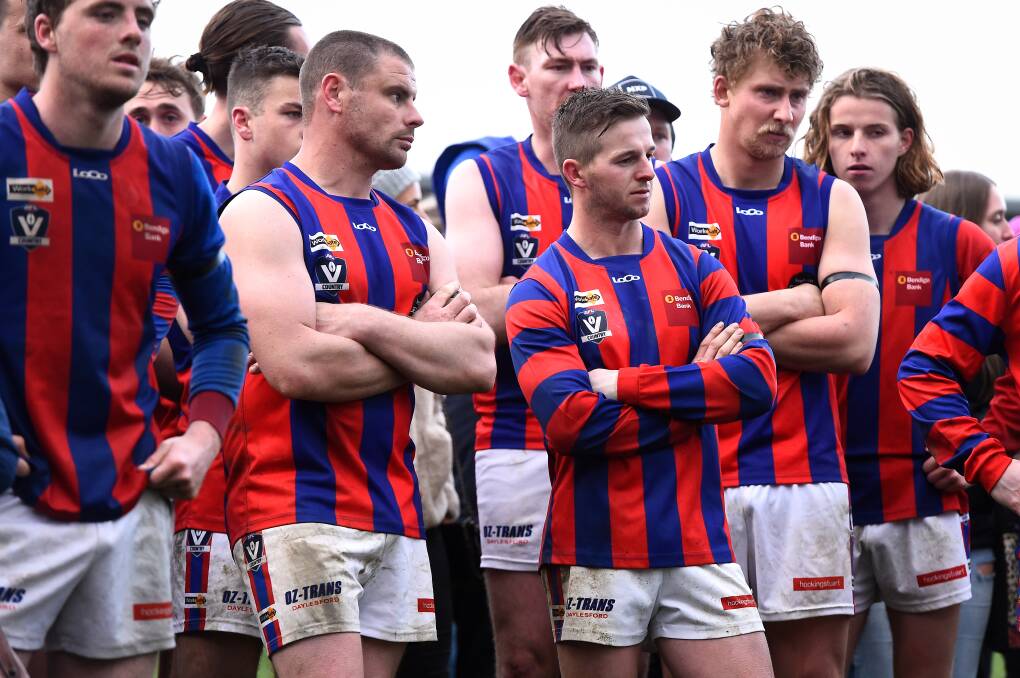 DISAPPOINTMENT: Hepburn players watch the post-match presentations after suffering a heavy defeat at the hands of Waubra.